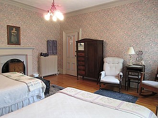 Guest room with period fireplace and antique furnishings