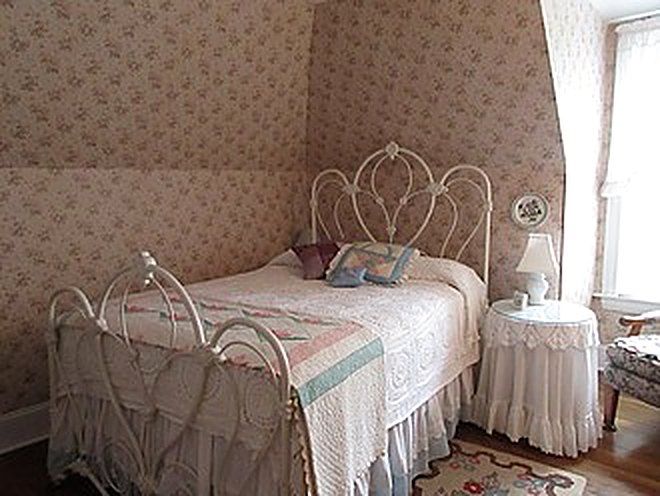 Guest bedroom with white iron bed