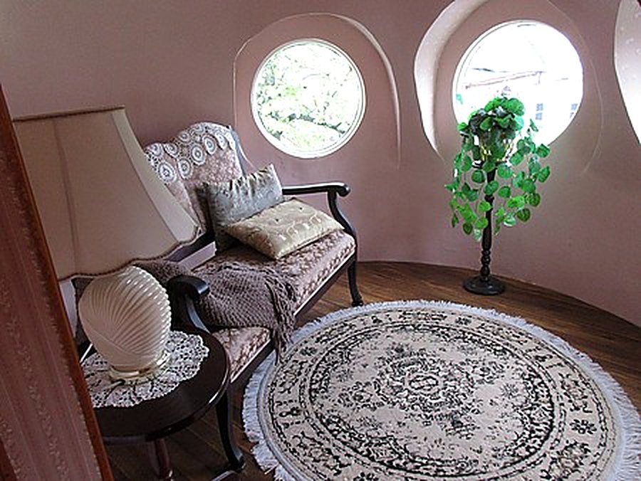 Round turret sitting room with antique settee and roundel windows